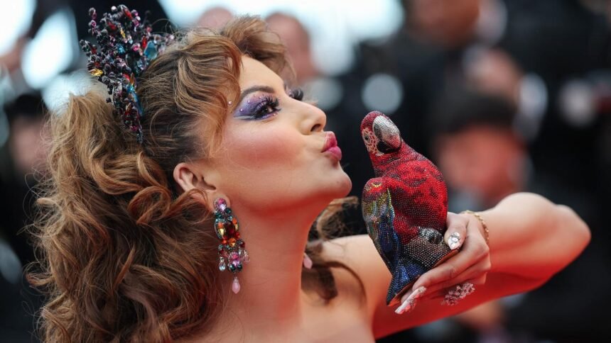 Urvashi Rautela Cannes 2025 – Urvashi Rautela poses with a Rs 4 lakh crystal parrot clutch at the Cannes 2025 red carpet. | Photo Credit: REUTERS
